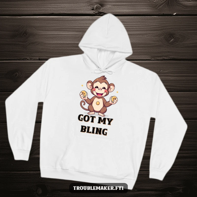 Funny smiling monkey juggling three shiny buttons, designed on a soft and warm hoodie.