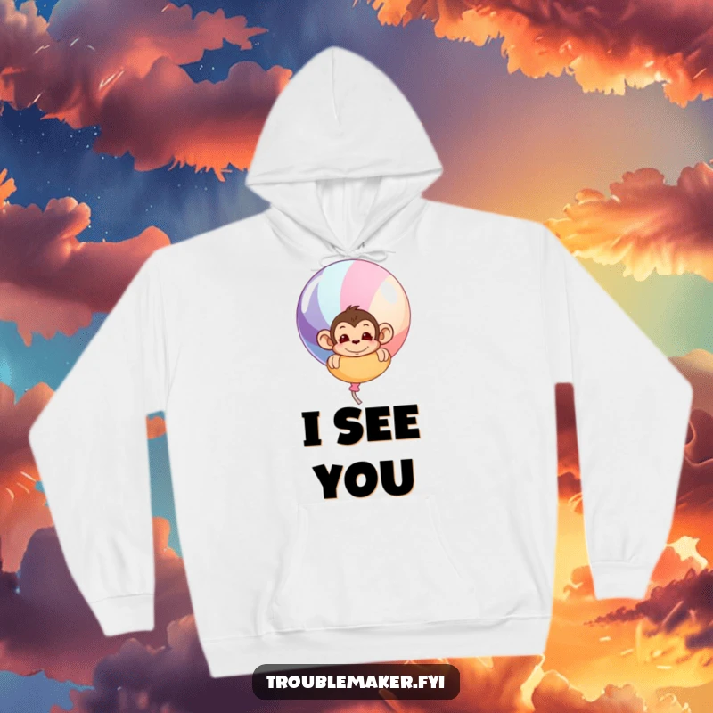 Funny hoodie depicting a mischievous monkey peeking around a big, colorful balloon, creating a sense of playful anticipation.