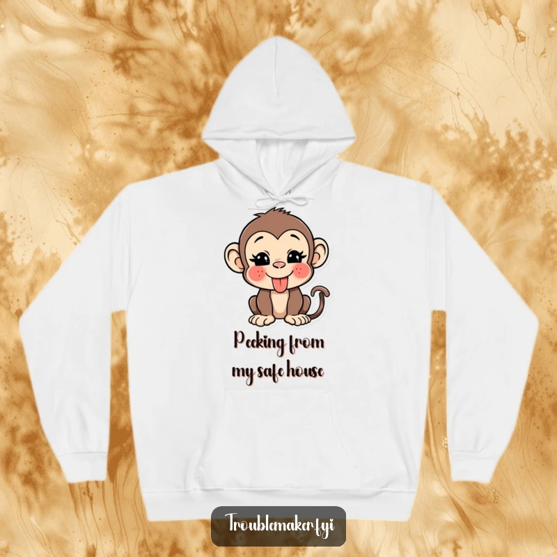 Funny monkey hoodie featuring a mischievous primate sticking its tongue out and winking, offering warmth and humor.