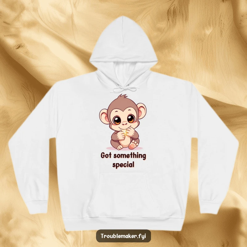 Funny hoodie featuring a monkey with bright, sparkling eyes, slyly hiding a gleaming object, offering cozy intrigue and humor.