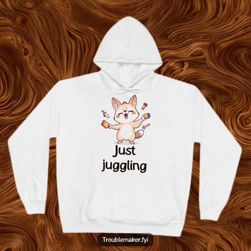 Funny hoodie featuring a stressed but determined animal character comically attempting to juggle several precarious objects, perfect for a laugh.