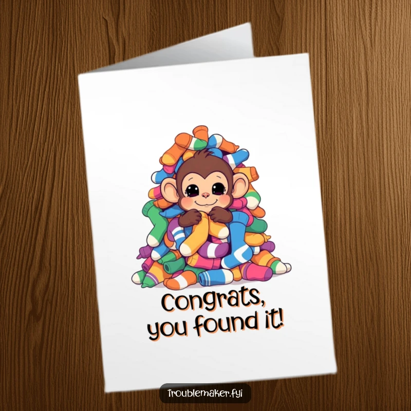 Funny Free Printable Congratulations Card featuring a monkey hiding behind a large pile of colorful socks.