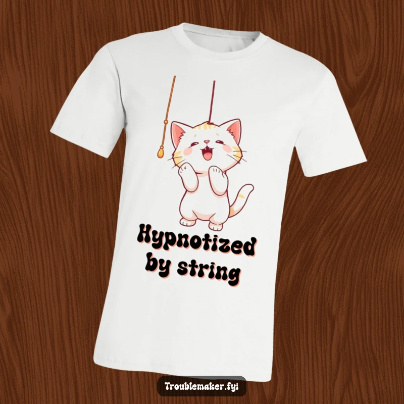 Funny t-shirt graphic of a cat energetically batting at a dangling string, capturing playful focus and feline mischief.